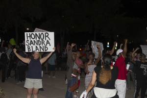 Protestors stand outside the Omni Hotel in downtown Dallas.
