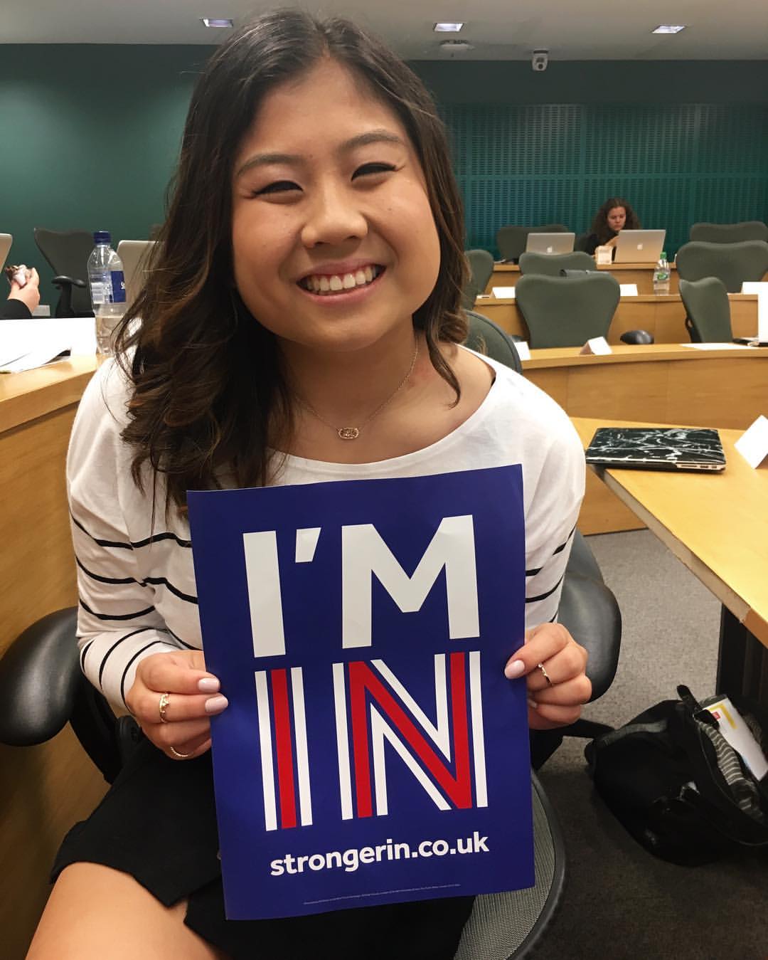 Rebecca Tjahja holds a sign supporting the U.K. staying in the European Union. The finance junior was studying abroad at the London School of Economics during the June 23 referendum. Photo courtesy of Rebecca Tjahja.