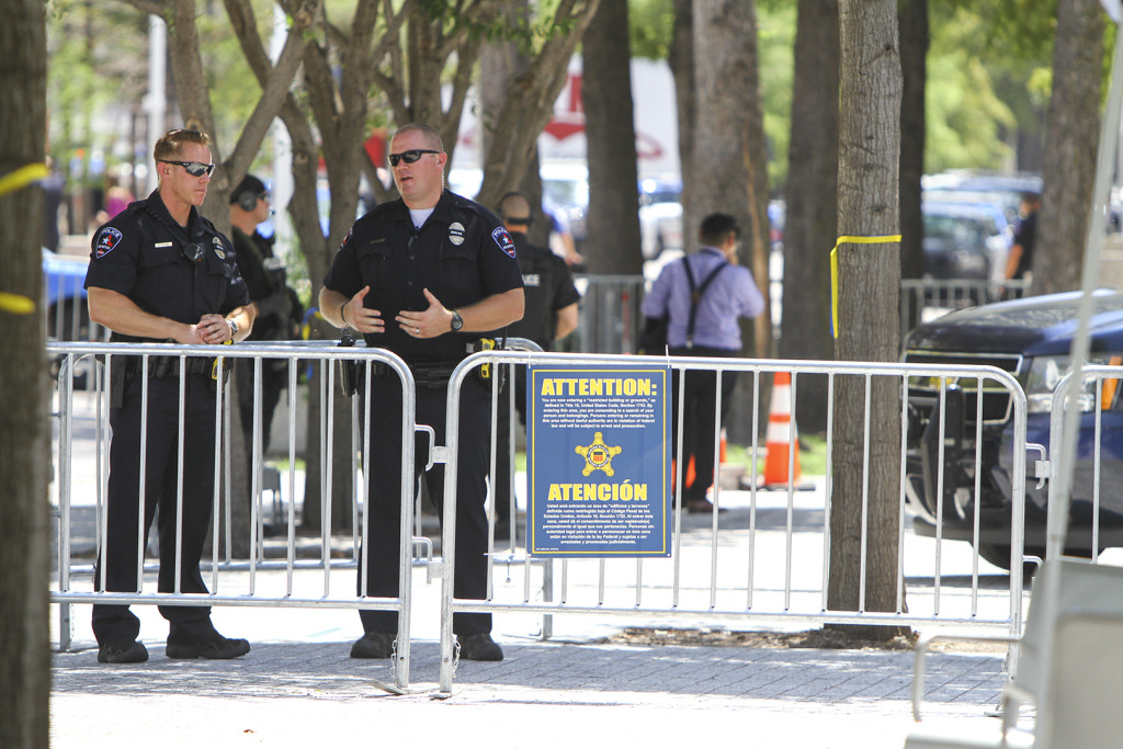 Police officers work to secure the area around the Morton H. Meyerson Symphony Center in preparation for the arrival of the President of the United States.