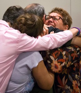Morris' mother, Jonni McElroy is embraced by the Morris family — courtesy Smiley N. Pool, Dallas Morning News