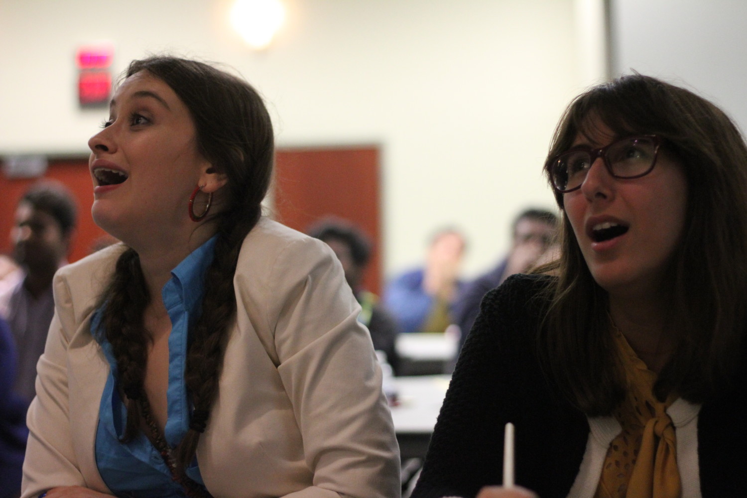 EMAC freshman Jules Rosen (left) and geoscience senior Hannah Ghotbi cheer as their preferred candidate takes the lead.