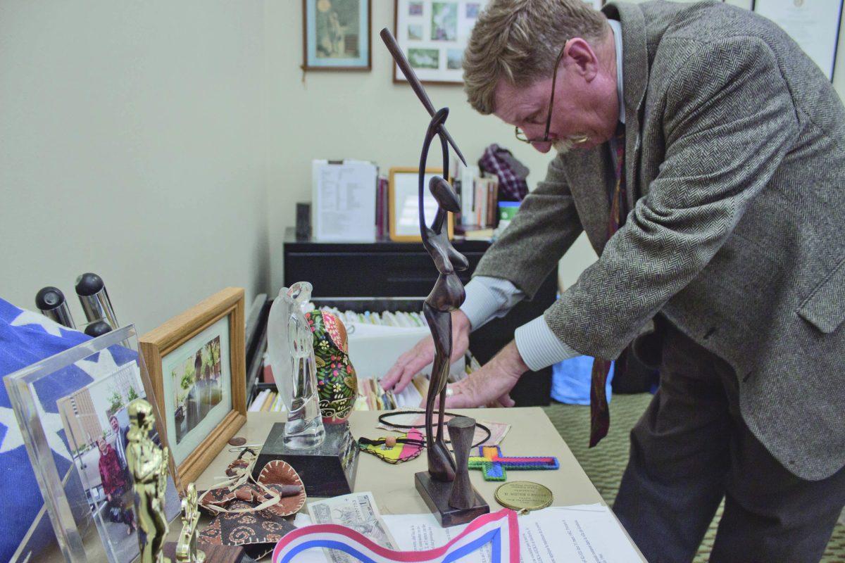 Pablo Arauz. The office of alumnus and HRI Executive Director Bill Holston is decorated with gifts he received from people he's helped over the years. The set of Russian stacking dolls was given by a Jewish man who was beaten because of his religion. Holston also has a photo of two Burmese youth workers. 