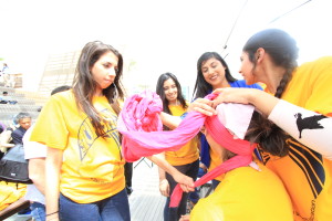 Yang Xi|Staff Gurbani Makkar, president of the Sikh Student Association helps tie a turban at Tie a Turban Day.
