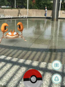 While playing "Pokemon Go," players come across various creatures in the game's augmented reality setup. Above, a user faces the water-type Pokemon "Krabby."