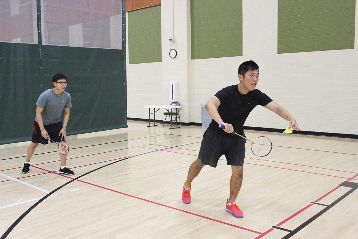 Two players on the Badminton team at UTD square off in Recreation Center West. Although participating in the club provides a social atmosphere, the team is making strides to focus more on competition. Photo by Ruth Varghese | Mercury Staff.