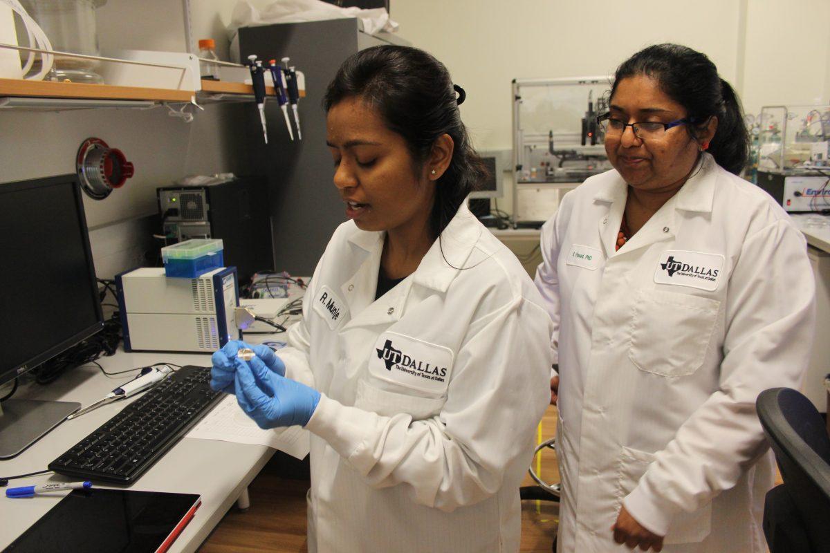 Biomedical engineering graduate student Rujuta Munje (left) explains how the blood sugar sensor works as Associate Department Head of Biomedical Engineering Shalini Prasad looks on. Prasad said the device could potentially help college students monitor blood sugar levels. Photo by Ruth Varghese | Mercury Staff.