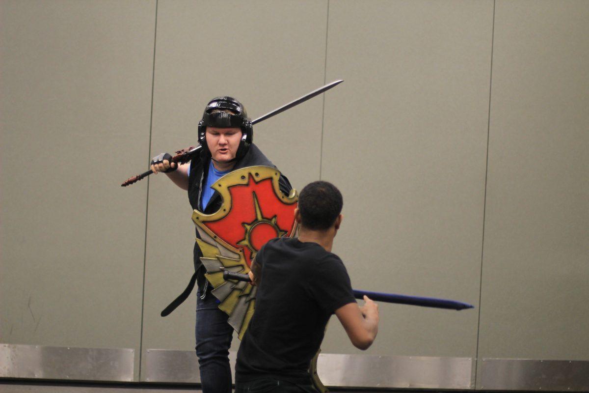 Psychology senior Zachary Joseph Burr (left) and ATEC senior Remone Durham practice swordplay. The Sword Arts club meets every week to discuss history, learn new techniques and showcase different weapons. Photo by Srichanrakiran Gottipati | Mercury Staff.