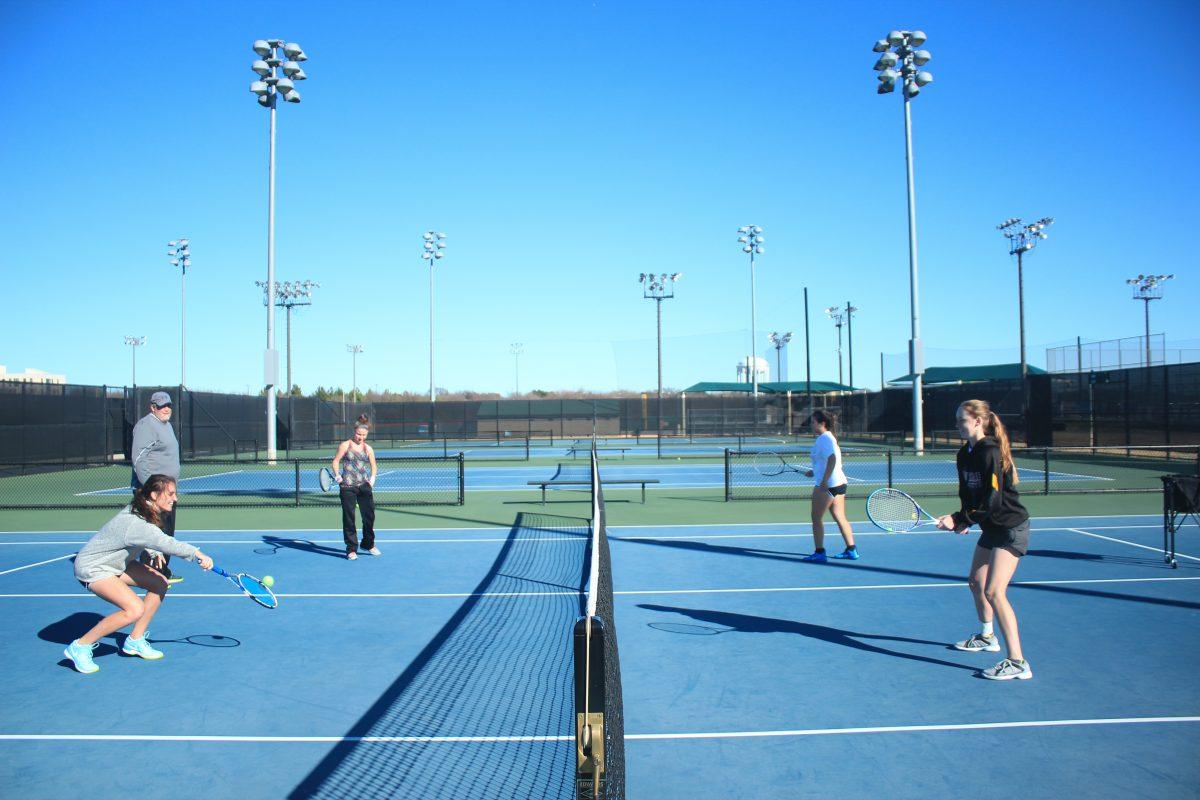 Head coach Bryan Whitt watches players on the women’s team practice picking up dropped shots at the net during a practice on Feb. 15 at the UTD tennis courts. Whitt, a five-time ASC Coach of the Year, is entering his 13th season at UTD. The women’s team lost the first two matches of the spring season (1-8, 4-5) while the men’s team won both (9-0, 5-4). Photo by Srikar Sudarsan Baskara | Mercury Staff.
