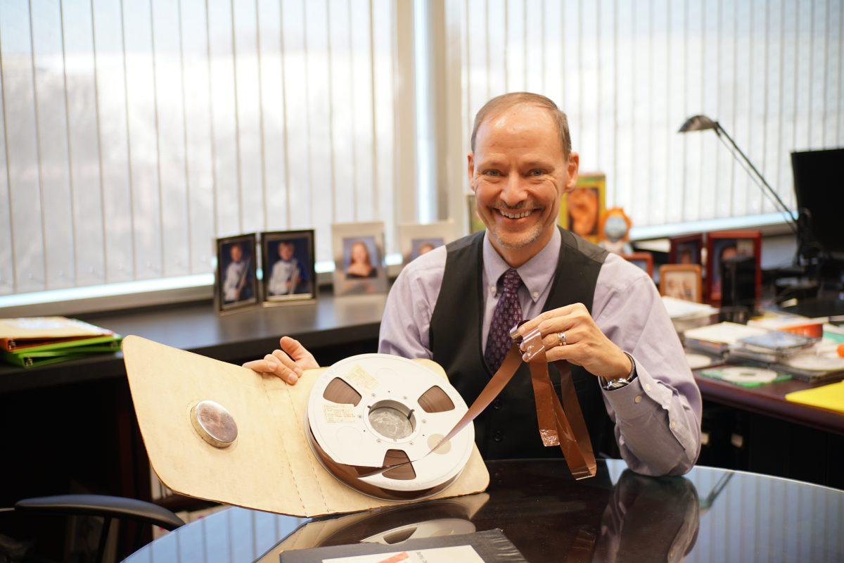 John Hansen, an electrical engineering professor, displays an audio reel from the Apollo 11 mission in 1969. In 2012, Hansen and his group began to convert the analog tapes into digital files. Photo by Anupam Gupta | Mercury Staff.