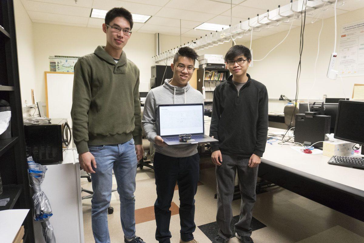 From the left, Computer science freshman Daniel Zhang and seniors Tam Nguyen and Caleb Fung pose with their device, which uses motion data to detect car crashes. Photo by Anupam Gupta | Mercury Staff.