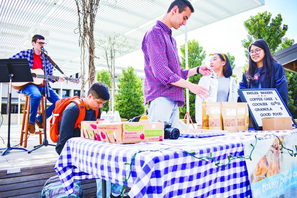 Entrepreneurship and marketing junior Andrew Blodgett (center) founded Smiles Bakery in 2016 before he started hosting pop-up events on campus in 2018. Photo by Anna Phengsakmueang | Mercury Staff.