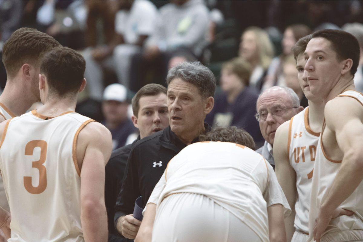 Coach Butterfield discusses strategy with his players during a time out. Photo by Vedant Sapra | Mercury Staff