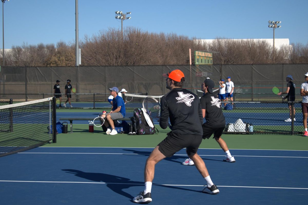 UTD tennis players Dubois and Zanellato rally during a doubles match.