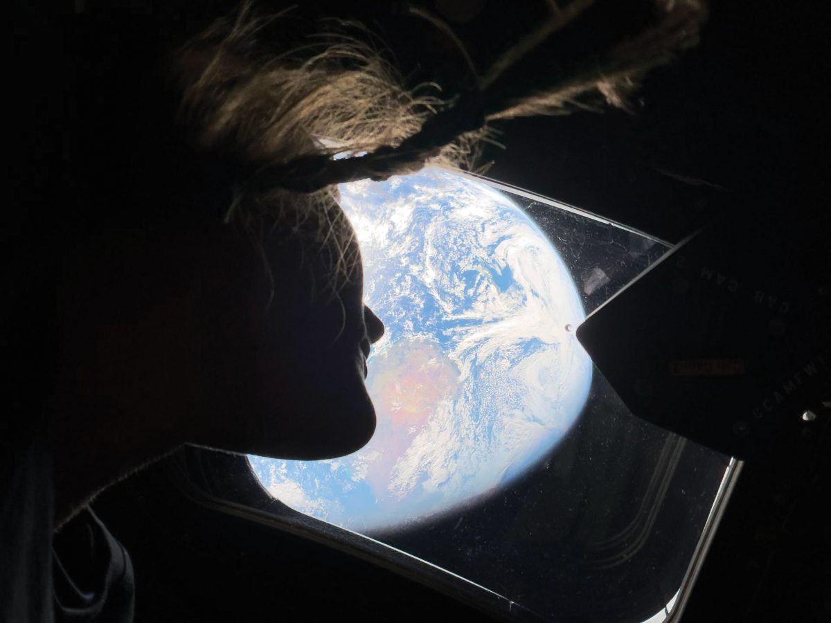 NASA astronaut Christina Koch looks at earth from the Orion spacecraft.