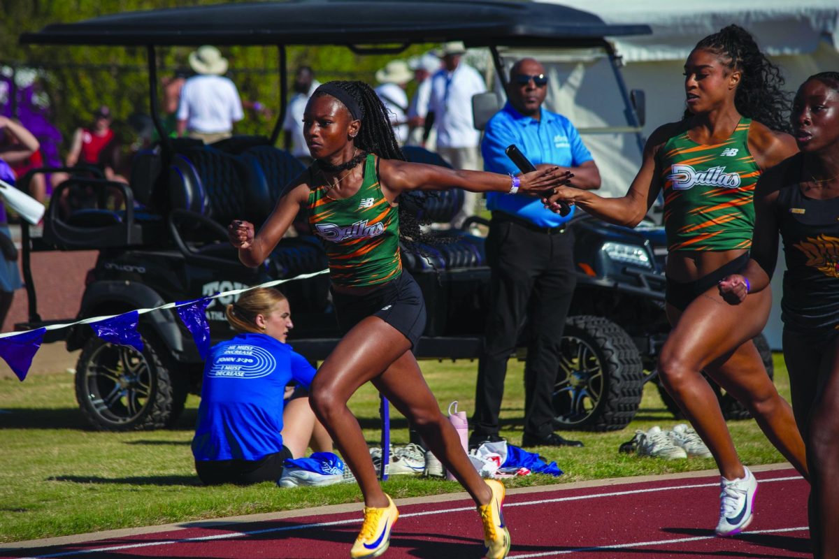 Freshman E'mon Mason retrieves the baton in the 4x400 relay race.