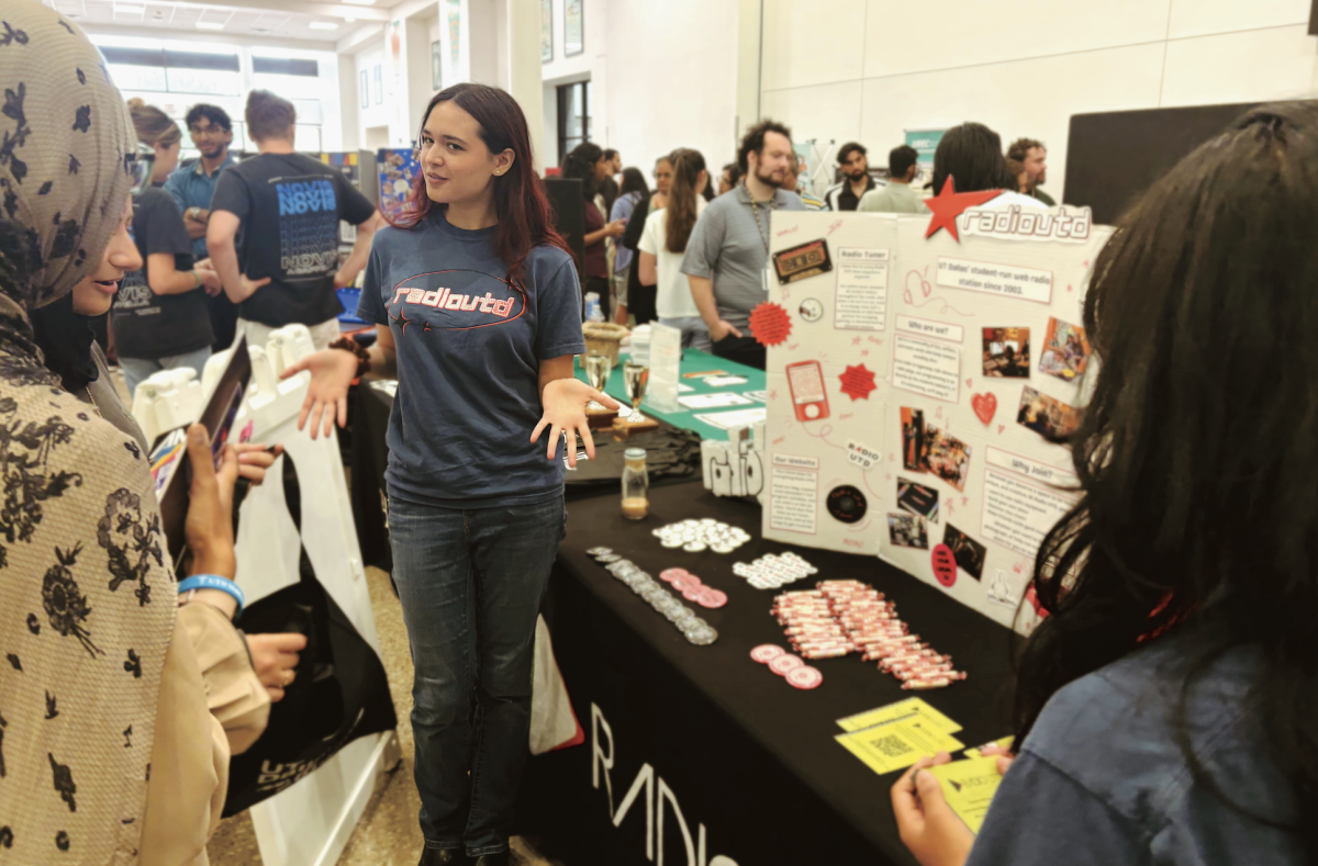 Students visit the RadioUTD table during a campus organization fair.
